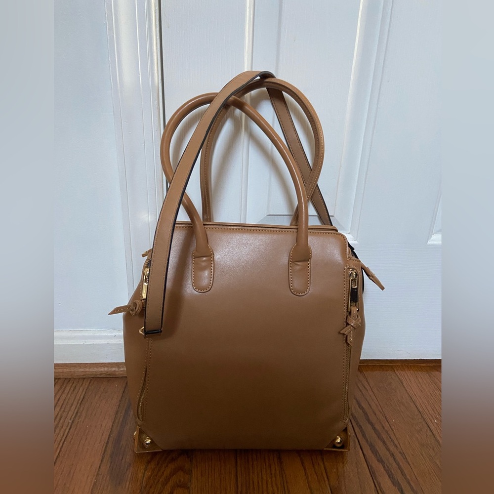 Lionel Crossbody Bag. Top Handle Carry. Sides Expand.